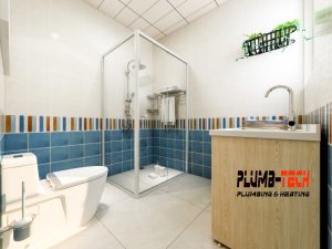 a modern bathroom with a toilet and shower clogged